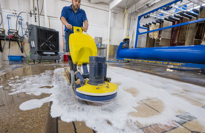 worker using machine for carpet tufting