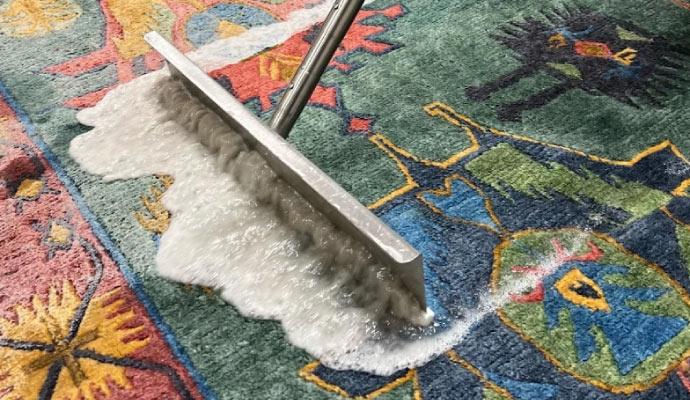 The rug is being cleaned with soapy water