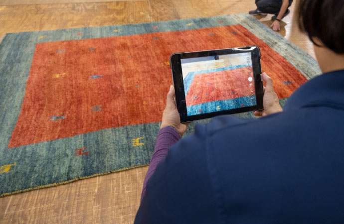 worker inspecting rug